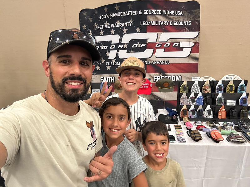 Tony Palacios and three of his kids at the Armor Of God Tactical Supply Co. booth