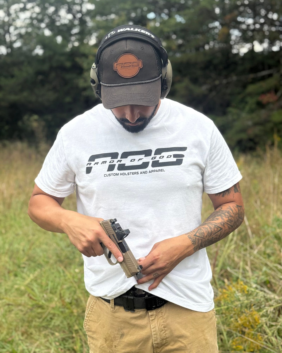 White AOG shirt worn on the range while drawing from an AOG holster