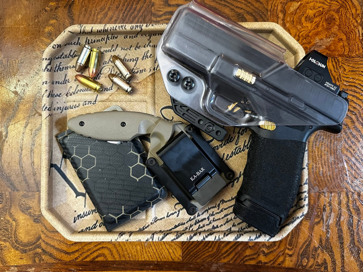 Everyday carry setup with an Armor Of God holster, Kydex magazine carrier and Hellcat Pro